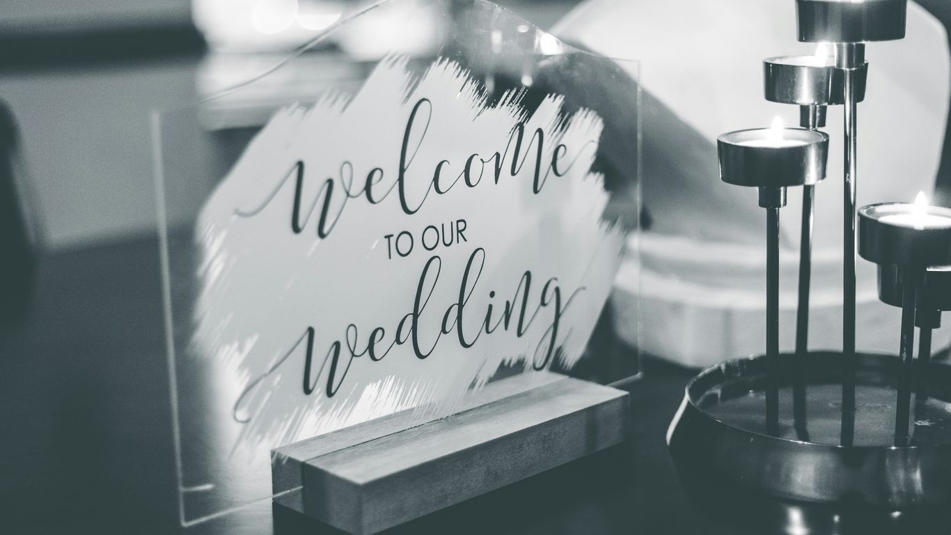 a black and white photo of a welcome sign