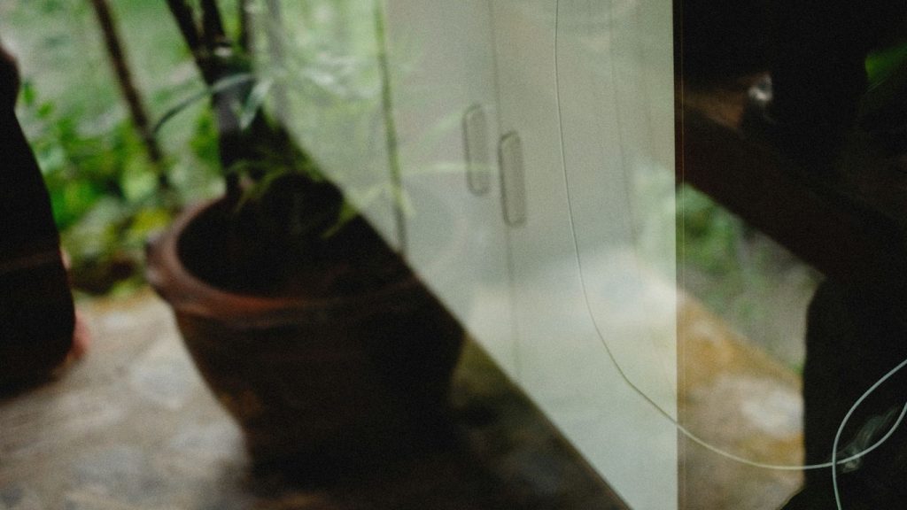 a window sill with a potted plant next to it