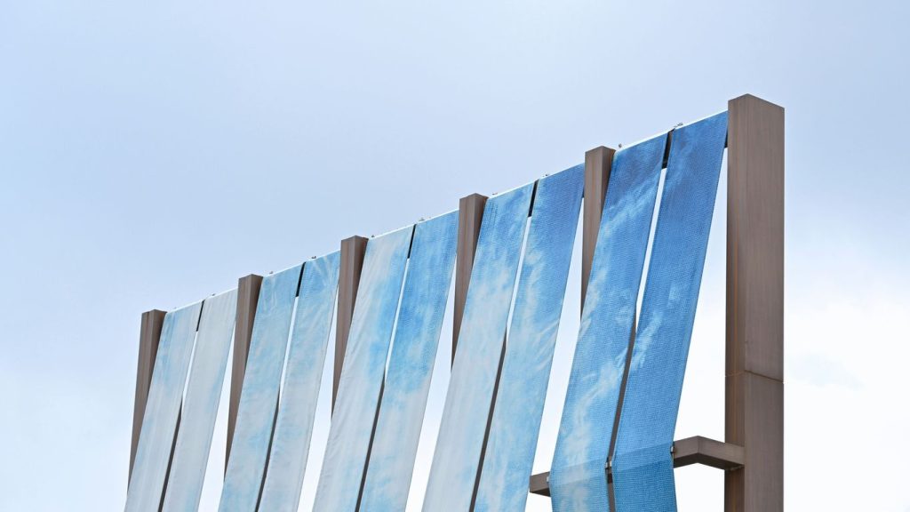 A large metal structure with a blue sky in the background