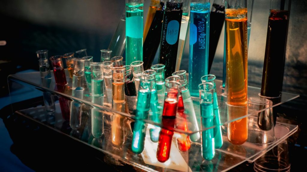 a bunch of test tubes filled with different colored liquids