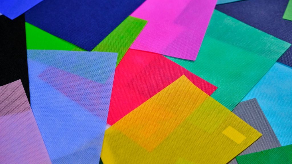 a pile of multicolored papers sitting on top of each other
