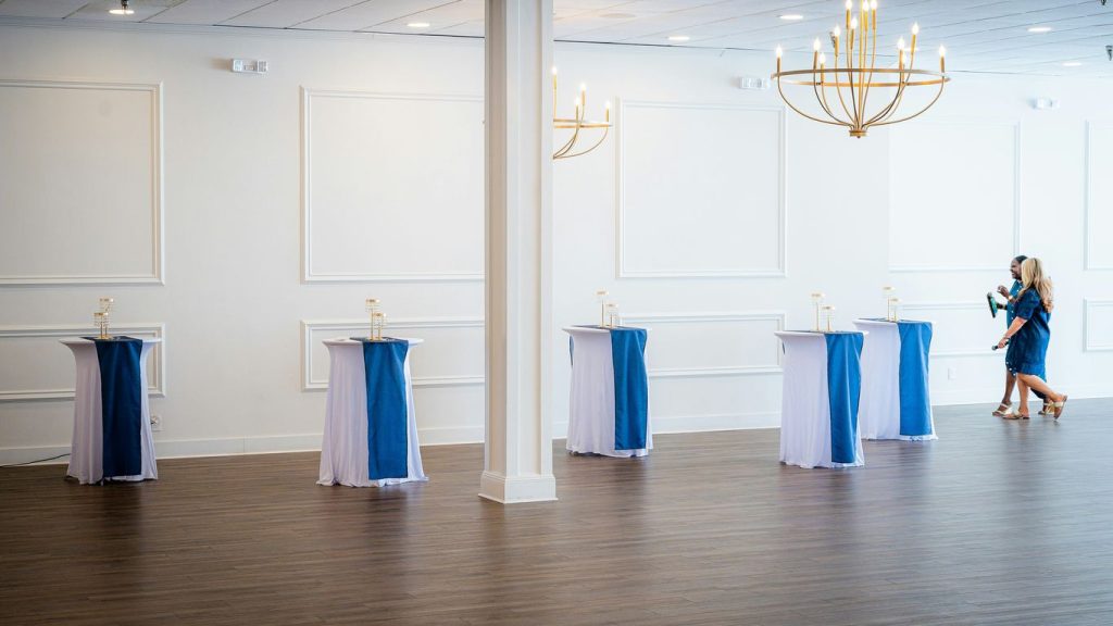 Empty event space with decorated high-top tables