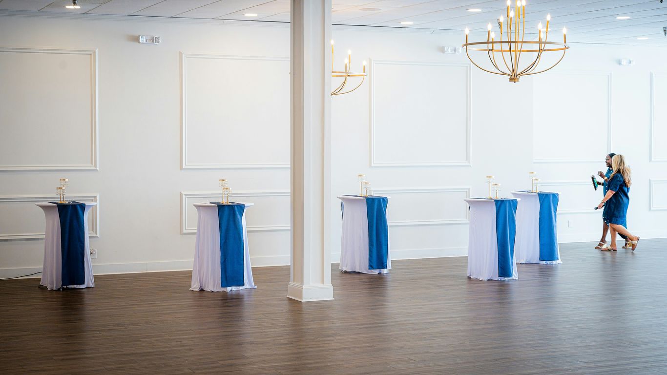 Empty event space with decorated high-top tables